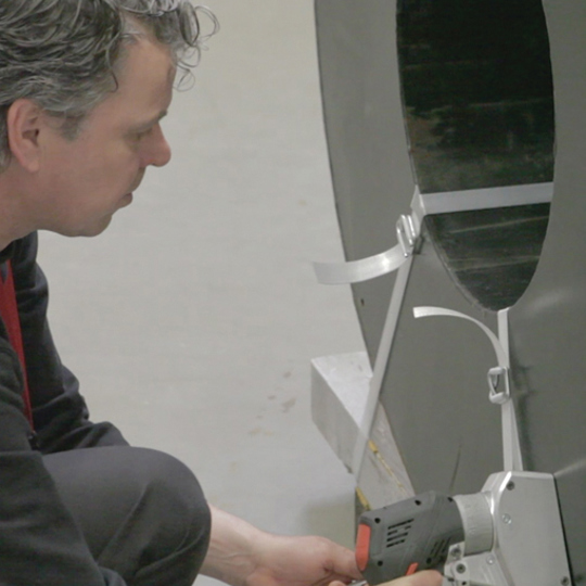 Man securing load using CBT35 Battery Tensioner